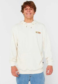 Crème hoodie met verstelbare trekkoorden en een vo zak, voorzien van het "RIP CURL" logo in oranje. Zachte textuur en een relaxed fit.