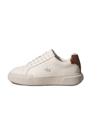 White low-top sneaker with thick sole and brown heel tab, featuring Calvin Klein logo on the side.