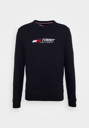 Czarna bluza z okrągłym dekoltem, długimi rękawami oraz białym i czerwonym logo "TOMMY HILFIGER" z przodu, wykonana z gładkiej tkaniny.