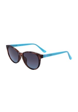 Occhiali da sole rotondi in tartaruga con lenti scure sfumate e aste azzurre brillanti con un piccolo dettaglio a forma di cuore.