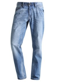 Ljusblå denimjeans med rak passform, framfickor och subtila blekning. Sömmen är synlig längs midjan och sömmarna.