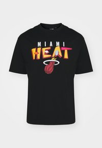 Camiseta negra con un gran gráfico que presenta "MIAMI" en blanco y "HEAT" en amarillo y rosa en negrita, junto con un logotipo de baloncesto en rojo.