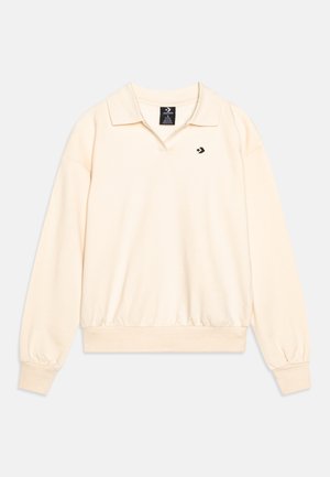 Pull en crème clair avec un col, manches longues et poignets côtelés. Présente un petit logo noir sur la poitrine gauche et un ourlet ajusté.