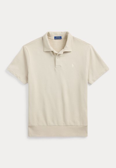 Beige kortærmet Polo Ralph Lauren-skjorte med krave, to-knaps placket, ribbet kant og lille broderet logo på venstre bryst.