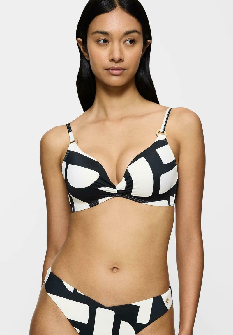Black and white bikini featuring a twisted design on the top, triangle cups, and gold accent hardware. The bottom has a matching pattern.