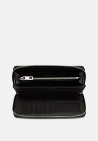 Portefeuille en cuir noir avec fermeture éclair, plusieurs emplacements pour cartes et un compartiment zippé pour les pièces de monnaie ; l'intérieur présente une texture lisse et un design épuré.