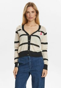 Beige cardigan with black stripes, v-neckline, button front, and ribbed cuffs. Features a small pink cherry design on the left side.