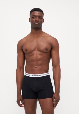 Black boxer shorts with a white elastic waistband featuring "BJÖRN BORG" logo. The fabric appears smooth with a fitted design.