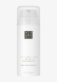 Baume Ultra Curl sans rinçage dans un flacon blanc élégant avec un capuchon transparent. Contient de l'huile d'argan et de l'huile de noix de coco. Présente un logo en relief et un texte doré.