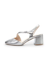 Silver metallic slingback shoe with a pointed toe and a chunky heel. Features a cut-out design and adjustable buckle strap. Smooth texture.