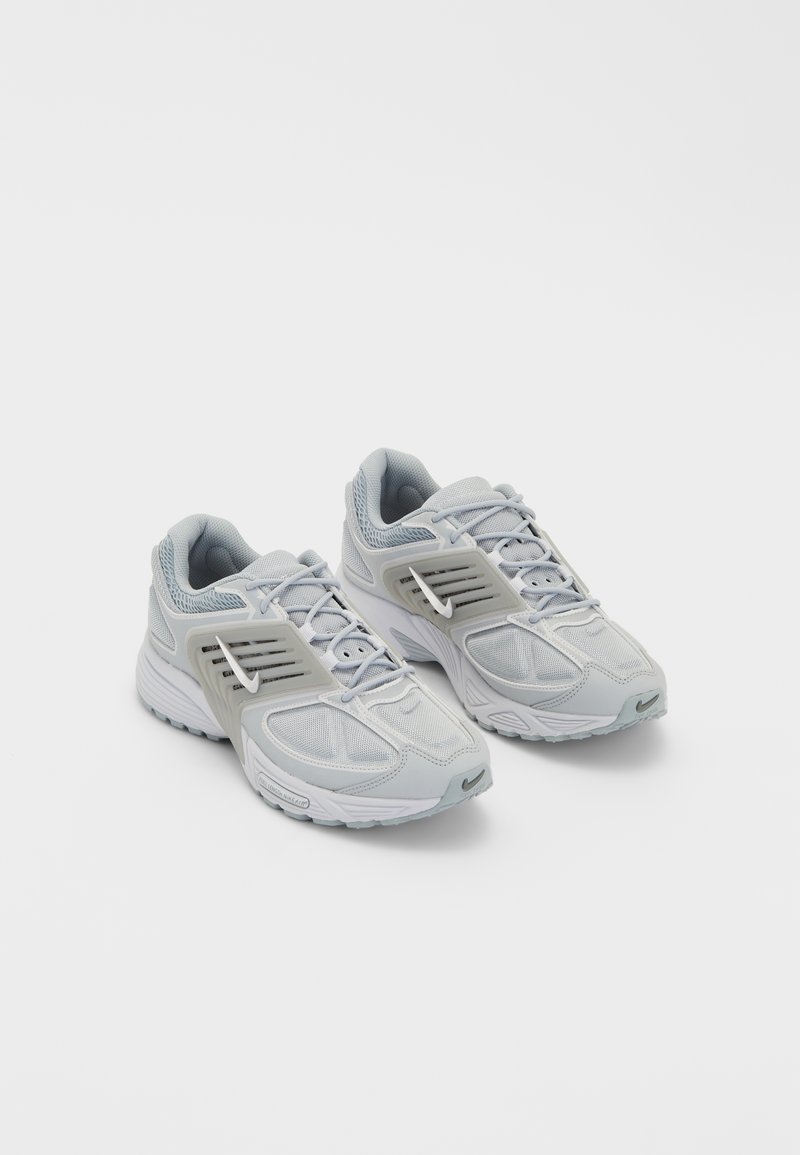 Gray athletic shoes with mesh and synthetic overlays; features a cushioned sole, lace-up design, and a white logo detail on the side.