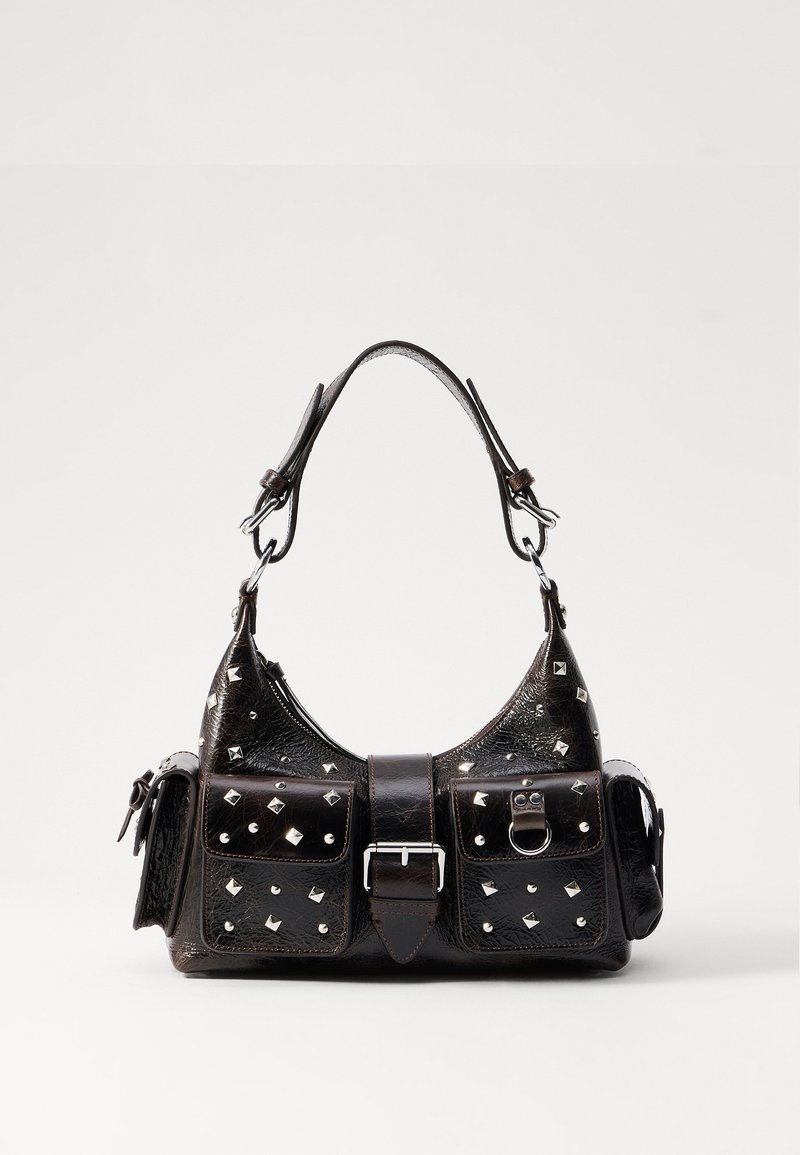 Saco de couro preto com detalhes em studded, forma retangular, dois bolsos frontais e uma alça curvada no topo. Detalhes de fecho de fivela e pressão.