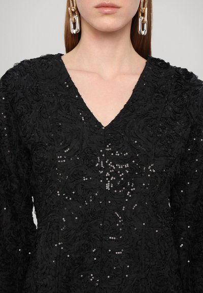 Black dress with a V-neckline, textured rose pattern, and sequined embellishments. Features long sleeves and a fitted silhouette.