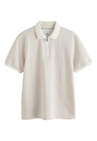 Polo de couleur beige clair avec un motif texturé, manches courtes et une patte de boutonnage zippée à moitié. Tissu en mélange de coton avec un col contrastant.