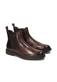 Braune Chelsea-Stiefel aus Leder mit elastischen Seitenteilen, runder Zehenpartie und Zuglaschen. Dicke Sohle mit strukturiertem Finish und gesteppten Details.
