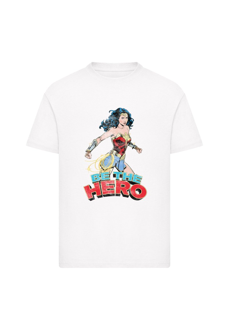 White cotton t-shirt featuring a colorful Wonder Woman graphic with the text "BE THE HERO" in bold red and blue. Short sleeves and crew neck.