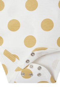 White baby onesie with large yellow polka dots. Features a snap bottom closure with metal snaps and soft cotton fabric.