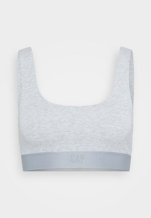 Hellgrauer Sport-BH mit breiten Trägern und einem dicken elastischen Saum am unteren Ende, auf dem sich ein dezentes GAP-Logo befindet.