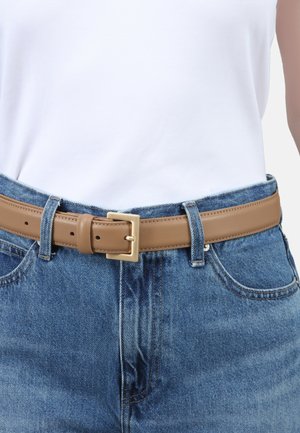 Tan leather belt with a rectangular gold-tone buckle, worn over blue denim jeans. The belt features evenly spaced holes for adjustment.