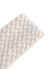 Tissu tissé de couleur crème avec un motif texturé en croisillons. Des fils épais et doux créent un aspect confortable et une surface tactile.