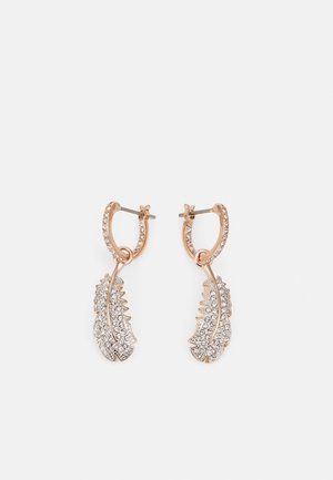 Rose gold hoop earrings with dangling leaf-shaped charms encrusted with small clear crystals on a white background.