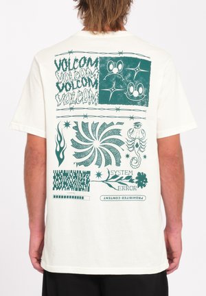 White cotton T-shirt featuring green graphic prints on the back, including text, shapes, and abstract designs like spirals and flames.