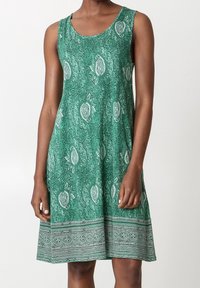 Robe sans manches verte avec un motif paisley, encolure arrondie, silhouette évasée et une bande d'ourlet à motif contrastant. Texture de tissu lisse.