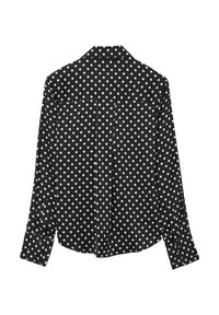 Schwarzes Langarmshirt mit einem weißen Punktmuster. Das Design umfasst einen Kragen und geknöpfte Manschetten mit lockerer Passform.
