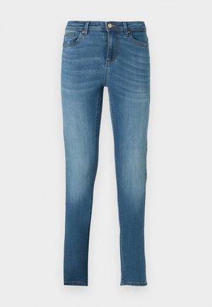 Skinny jeans made of light blue denim with a faded effect, five pockets, metal button closure, and subtle stitching details. Straight leg.