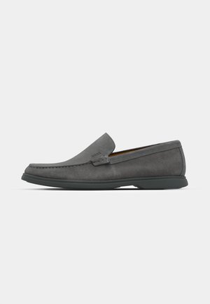 Grey suede loafers with a rounded toe, stitched detailing, and a low rubber sole. Features a slip-on design with no visible hardware.