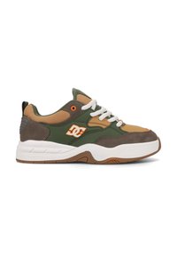 Green and tan sneaker featuring textured suede and mesh panels, white laces, orange accent, and a chunky white sole with brown tread.