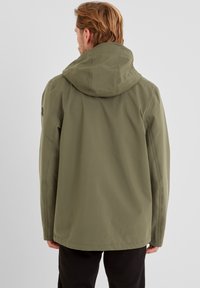 Olive green jacket features a hood, seamless design, and a straight cut. The fabric appears smooth with subtle stitching details.