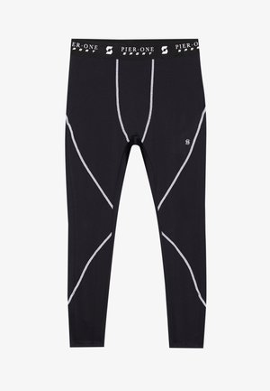 Leggings de sport noirs avec des coutures blanches contrastantes, dotés d'une taille élastique de marque et d'une coupe ajustée avec une texture lisse.