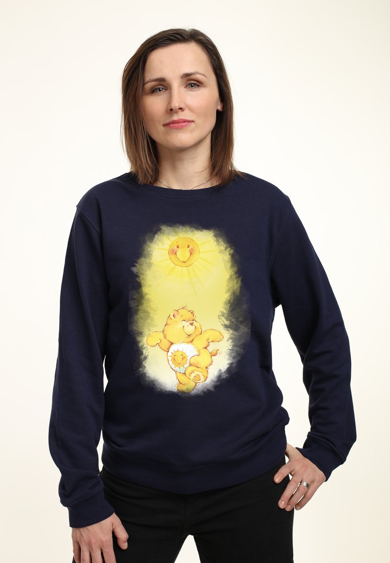 Mørkeblå sweatshirt med et cartoon-løve og sol design i gul. Blød tekstur med lange ærmer og en afslappet pasform.