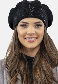 Beret negru din fetru cu modele decorative din mărgele, formă rotundă și o textură moale. Accentuat cu un detaliu metalic subtil.