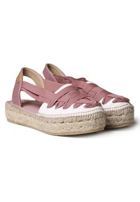 Rosa espadrilloskor med flätade remmar, canvasöverdel och sula av juterep. Öppen design med mjuk, slät textur.