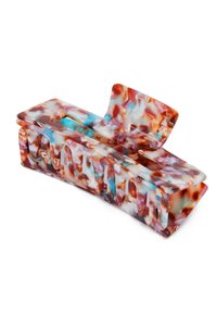 Fermaglio per capelli in plastica traslucida con motivo tartarugato, caratterizzato da ritagli ondulati e un design curvo, prevalentemente nei toni del marrone, blu e crema.