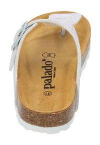 White thong sandal with a cork sole, tan suede footbed, and embossed brand logo. Features adjustable strap for a secure fit.