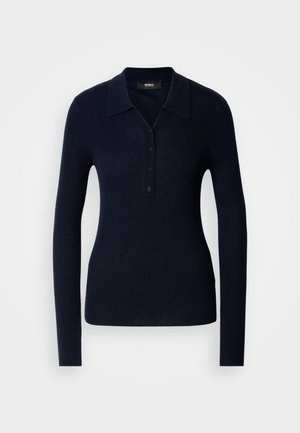 Marineblauwe polo met lange mouwen, gemaakt van gestructureerde ribstof. Het heeft een kraag, knoopsluiting en een aansluitende pasvorm.