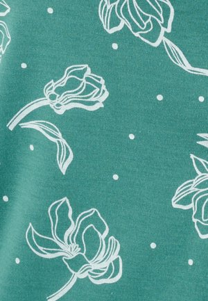 Teal fabric featuring white floral outlines and small white dots, with a smooth texture and casual design.