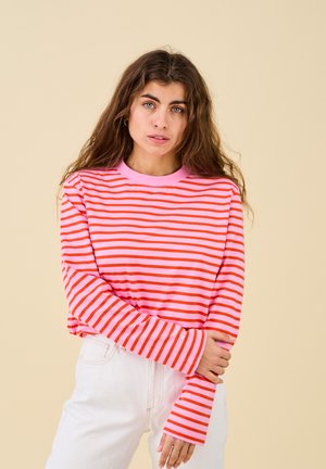 Long-sleeve striped shirt in pink and orange, featuring a round neckline and relaxed fit, with extra-long sleeves and soft cotton texture.