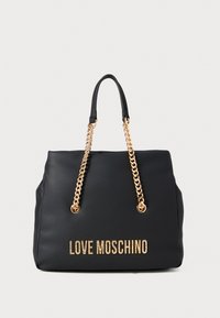 Black Love Moschino handbag with gold chain straps and gold lettering on the front, set against a plain light background.