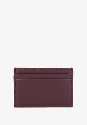 Burgundy leather cardholder with four slots and embossed logo. Smooth texture and contrasting stitching detail. Rectangular shape.