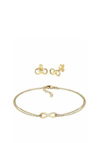 Gold-toned jewelry set featuring an infinity symbol bracelet with a double chain and matching stud earrings, all made of metal.