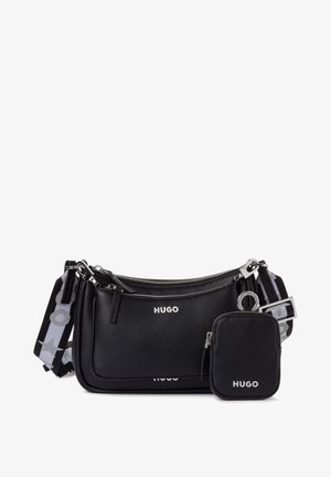Black leather crossbody bag with a textured finish, silver hardware, and detachable zippered pouch. Adjustable patterned strap with logo details.