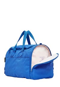 Sac de sport bleu en tissu texturé, avec deux poignées, fermeture éclair, et un intérieur rose arborant un message imprimé. Poche latérale zippée incluse.