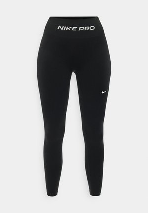 Μαύροι seamless κολάν Nike Pro με ψηλή μέση, με λευκό λογότυπο Nike στη μηριαία περιοχή και το κείμενο "NIKE PRO" στη ζώνη της μέσης.