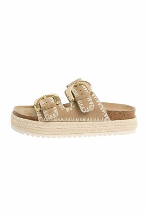 Beige slide sandal with two buckled straps, white zigzag stitching, cork footbed, braided platform sole, and ridged white outsole.