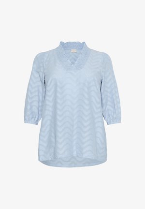 Vaaleansininen pusero, jossa on V-pääntie, röyhelökaulus ja kolmen neljänneksen puffihihat. Sisältää tekstuurilla varustetun siksak-kuosin kauttaaltaan.