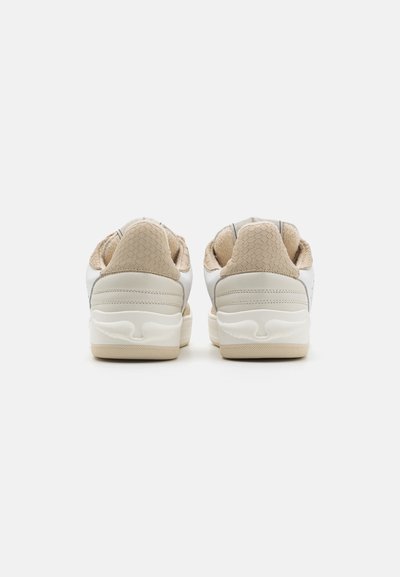 White sneakers with beige accents, textured heel, smooth sides, and rubber outsole. Features rounded design and padded collar for comfort.